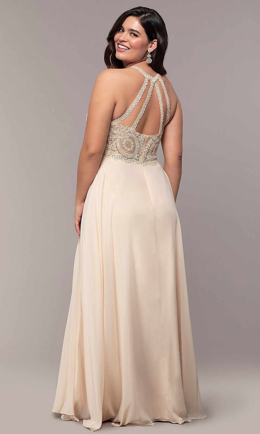 A woman stands smiling over her shoulder in a Long Chiffon Embroidered-Bodice Prom Dress, featuring a sleeveless design, embellished open back, and flowing floor-length skirt.
